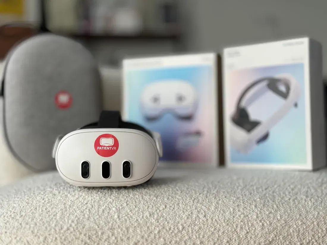A Meta Quest headset with a PatientVR sticker in front of its retail boxes