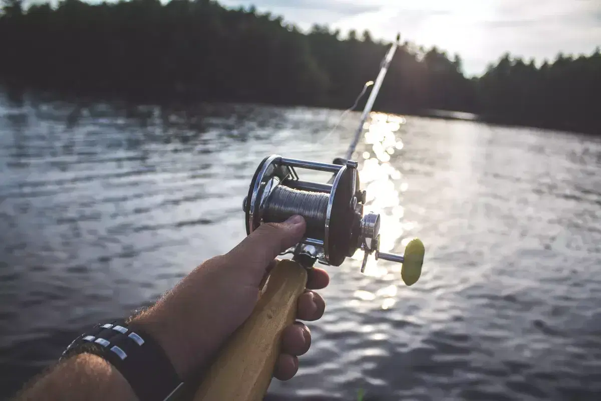 Angler holding a rod and reel over a river